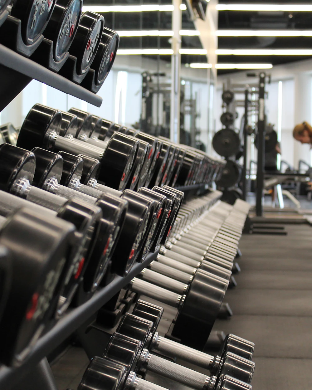 Dumbbell racks on the Iron Man Academy training floor